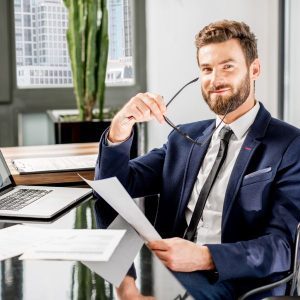 Happy young businessman representing positive business trends.