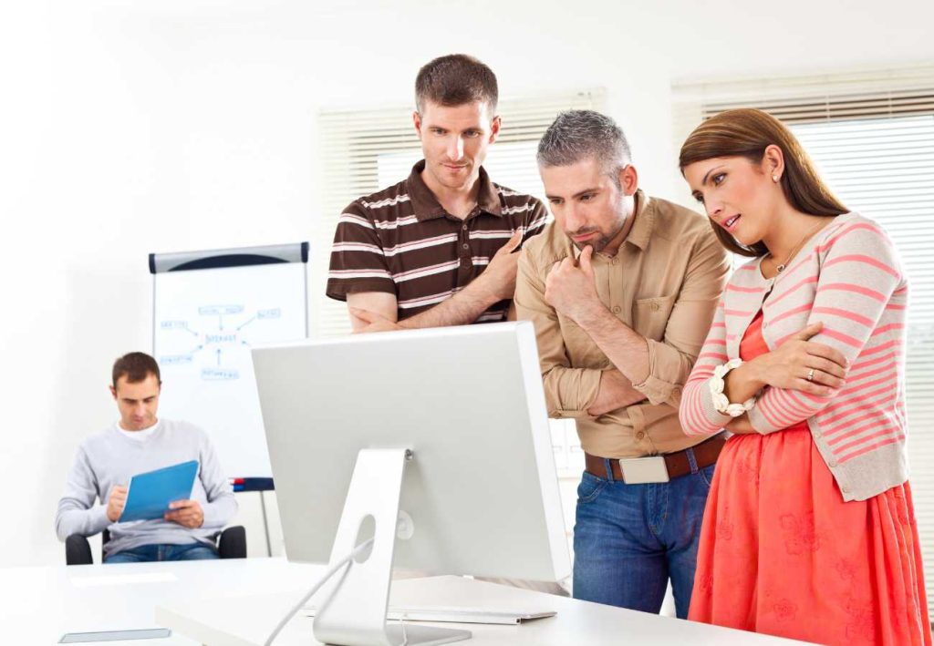 Small business team reviewing business services for startups on a desktop screen.