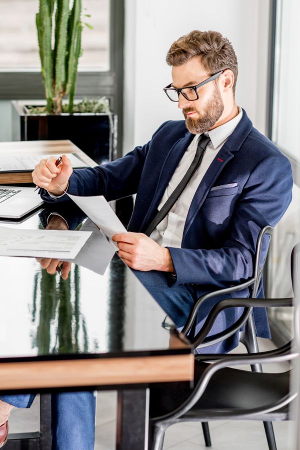 Businessman carefully reviewing document for global business solutions.